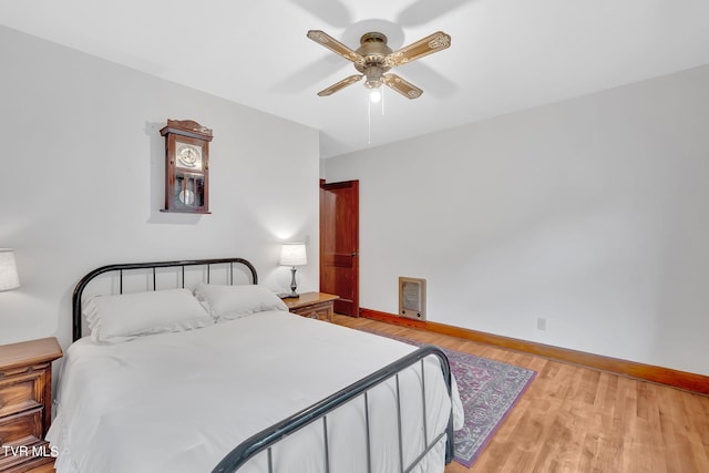 8836 Bristol Hwy, Hiltons, VA 24258 - bedroom with light wood-type flooring, baseboards, a ceiling fan, and heating unit