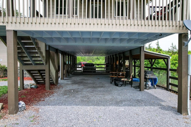 558 Oakland Dr, Bybee, TN 37713 - view of parking / parking lot with stairway, a carport, and gravel driveway