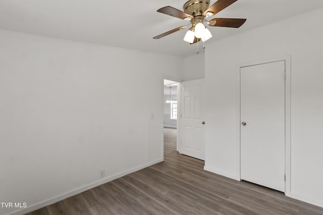 558 Oakland Dr, Bybee, TN 37713 - unfurnished bedroom featuring wood finished floors, baseboards, and a ceiling fan
