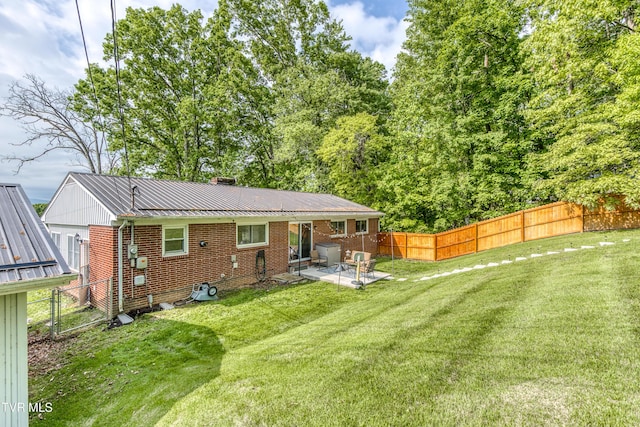 963 NE Woodlawn Ter, Abingdon, VA 24210 - rear view of property featuring a patio, brick siding, metal roof, and a chimney
