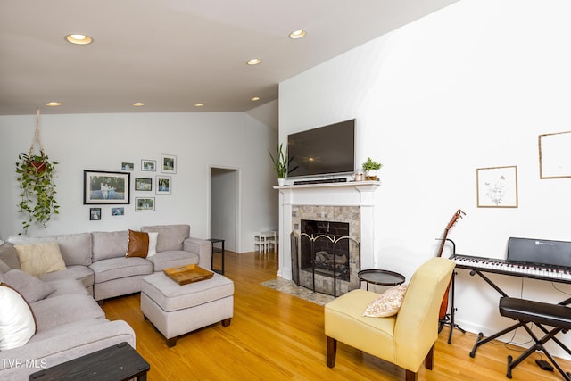 963 NE Woodlawn Ter, Abingdon, VA 24210 - living room featuring light wood-style floors, vaulted ceiling, a fireplace, and recessed lighting