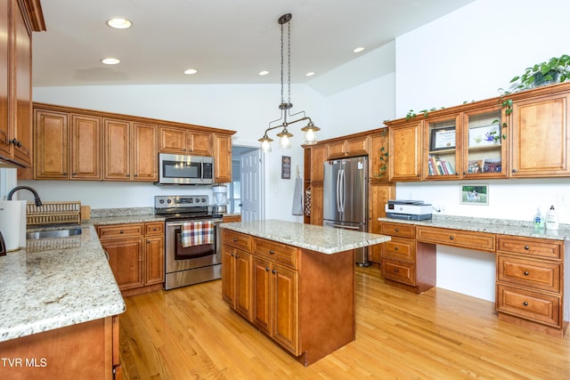 963 NE Woodlawn Ter, Abingdon, VA 24210 - kitchen with appliances with stainless steel finishes, a sink, brown cabinetry, light wood finished floors, and a center island