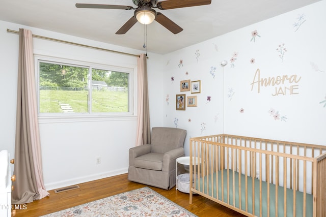 963 NE Woodlawn Ter, Abingdon, VA 24210 - bedroom with wood finished floors, a nursery area, baseboards, and a ceiling fan