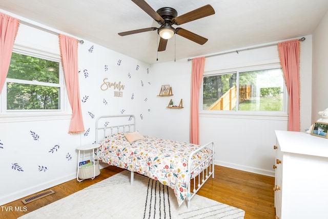963 NE Woodlawn Ter, Abingdon, VA 24210 - bedroom with multiple windows, wood finished floors, and baseboards