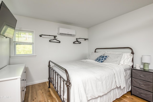 963 NE Woodlawn Ter, Abingdon, VA 24210 - bedroom with a wall unit AC, light wood finished floors, and baseboards