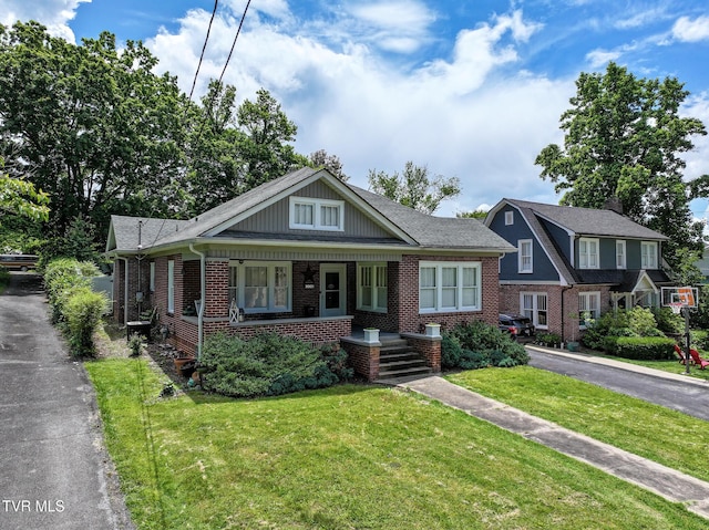 408 N Main St, Greeneville, TN 37745 - bungalow with brick siding, a front lawn, and a porch