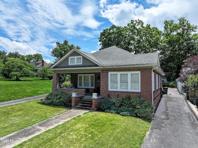 408 N Main St, Greeneville, TN 37745 - bungalow with covered porch, brick siding, a front yard, and a gate