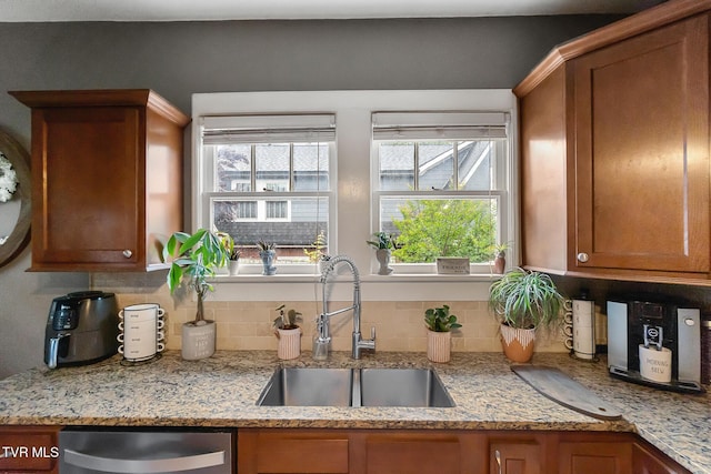 408 N Main St, Greeneville, TN 37745 - kitchen with a sink, stainless steel dishwasher, backsplash, brown cabinets, and healthy amount of natural light