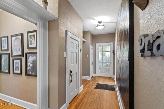 408 N Main St, Greeneville, TN 37745 - hallway with a textured wall, wood finished floors, and baseboards