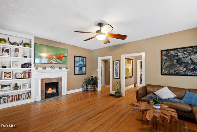 408 N Main St, Greeneville, TN 37745 - living area with ceiling fan, light wood-style floors, a tiled fireplace, and baseboards