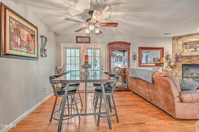 204 E Mountain View Rd # 20, Johnson City, TN 37601 - dining space featuring ceiling fan, light wood-type flooring, baseboards, and a fireplace