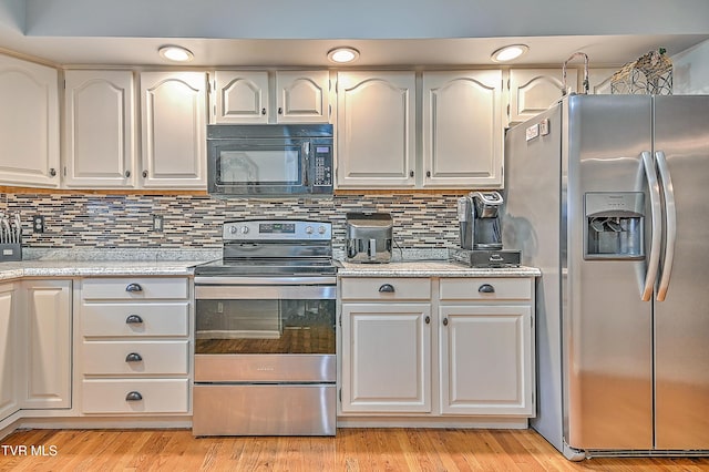 204 E Mountain View Rd # 20, Johnson City, TN 37601 - kitchen with appliances with stainless steel finishes, white cabinets, decorative backsplash, light wood-style floors, and light stone countertops