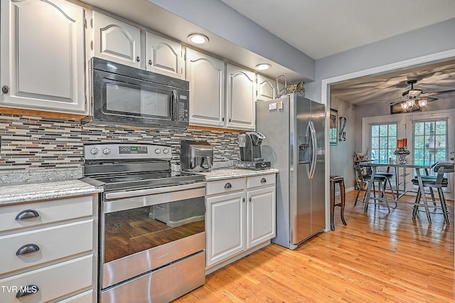 204 E Mountain View Rd # 20, Johnson City, TN 37601 - kitchen with stainless steel appliances, ceiling fan, tasteful backsplash, light wood-style floors, and white cabinetry