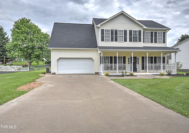 colonial house with a porch, concrete driveway, and an attached garage