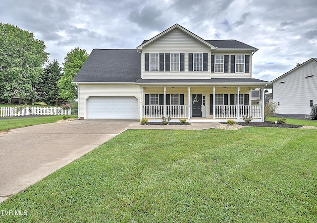 colonial house with a porch, concrete driveway, and a garage