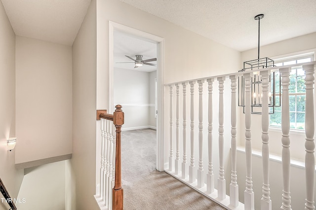 hallway with carpet flooring and baseboards