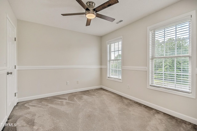 empty room featuring baseboards, carpet, and a ceiling fan