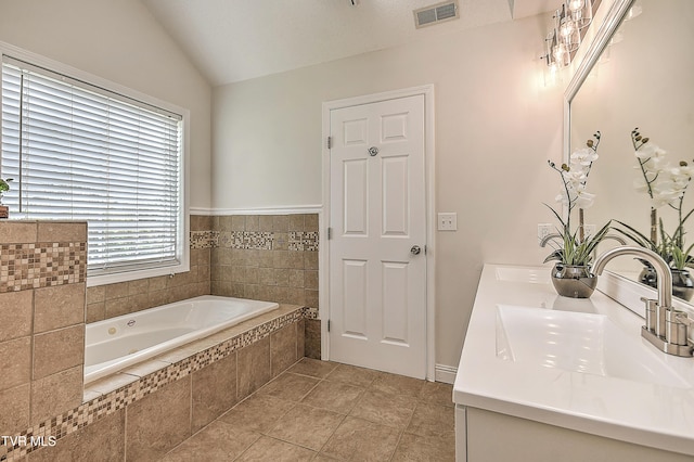 bathroom with lofted ceiling, a bath, double vanity, and tile patterned flooring