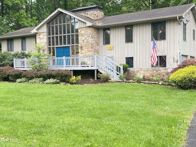 203 Oak Ln, Johnson City, TN 37604 - view of front of property with stone siding, a deck, a front yard, and roof with shingles
