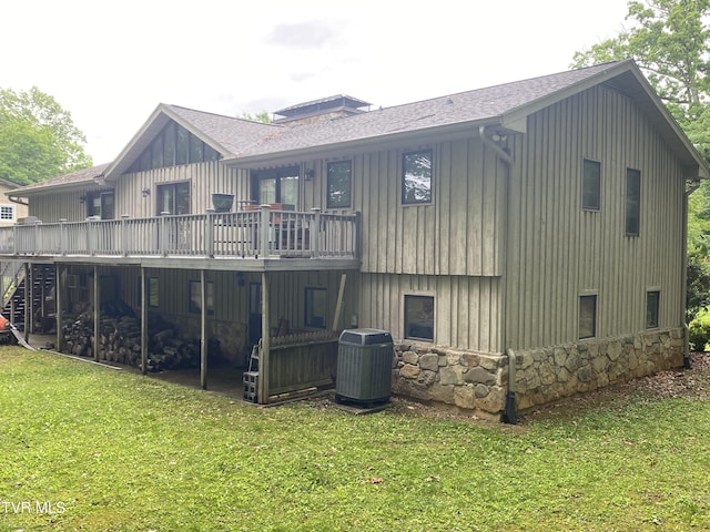 203 Oak Ln, Johnson City, TN 37604 - rear view of house with cooling unit, a wooden deck, a lawn, roof with shingles, and stone siding