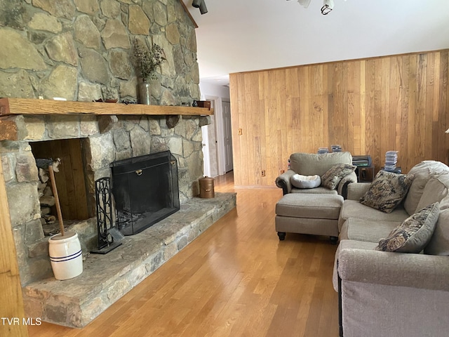203 Oak Ln, Johnson City, TN 37604 - living area featuring wood finished floors, wooden walls, and a stone fireplace