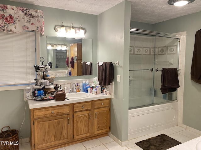 203 Oak Ln, Johnson City, TN 37604 - bathroom featuring tile patterned flooring, a textured ceiling, vanity, enclosed tub / shower combo, and baseboards