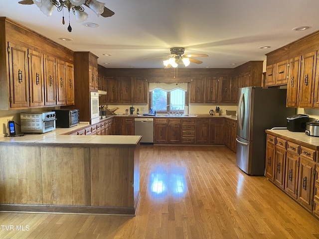 203 Oak Ln, Johnson City, TN 37604 - kitchen featuring a ceiling fan, stainless steel appliances, light wood finished floors, and tile counters