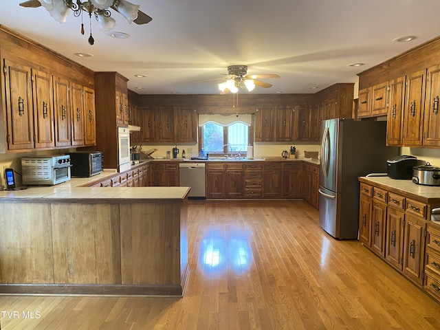 203 Oak Ln, Johnson City, TN 37604 - kitchen featuring ceiling fan, stainless steel appliances, a sink, and light wood finished floors