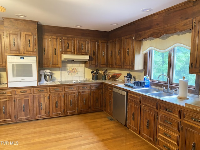 203 Oak Ln, Johnson City, TN 37604 - kitchen with white oven, dishwasher, under cabinet range hood, a sink, and black electric stovetop