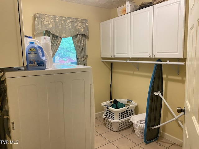 203 Oak Ln, Johnson City, TN 37604 - laundry area featuring cabinet space, washer / clothes dryer, light tile patterned floors, and baseboards