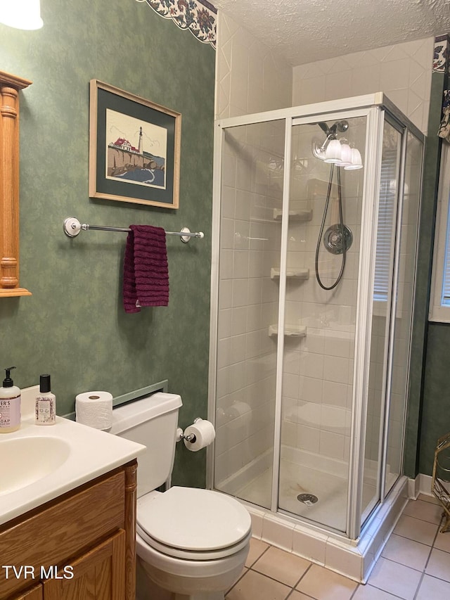 203 Oak Ln, Johnson City, TN 37604 - full bathroom featuring a stall shower, tile patterned floors, vanity, a textured ceiling, and toilet