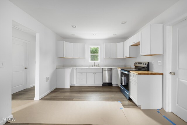 1410 Anderson St, Bristol, TN 37620 - kitchen with appliances with stainless steel finishes, a sink, white cabinets, light wood-type flooring, and recessed lighting