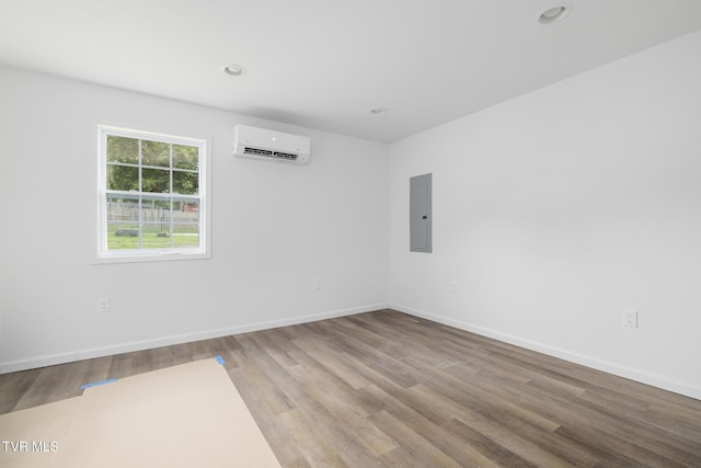 1410 Anderson St, Bristol, TN 37620 - unfurnished room with a wall mounted air conditioner, electric panel, wood finished floors, baseboards, and recessed lighting