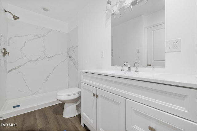 1410 Anderson St, Bristol, TN 37620 - bathroom with wood finished floors, a marble finish shower, vanity, and toilet
