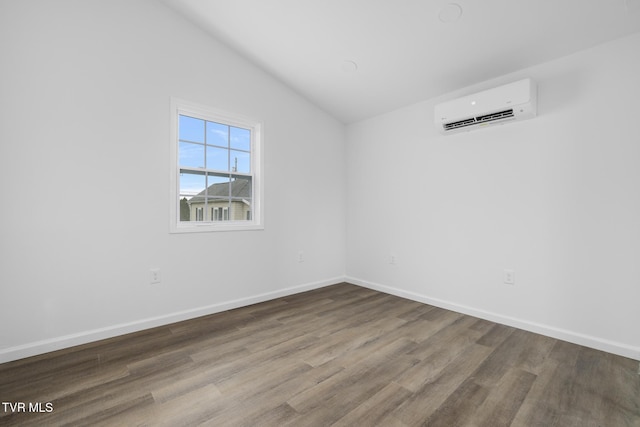 1410 Anderson St, Bristol, TN 37620 - spare room with a wall mounted AC, lofted ceiling, wood finished floors, and baseboards