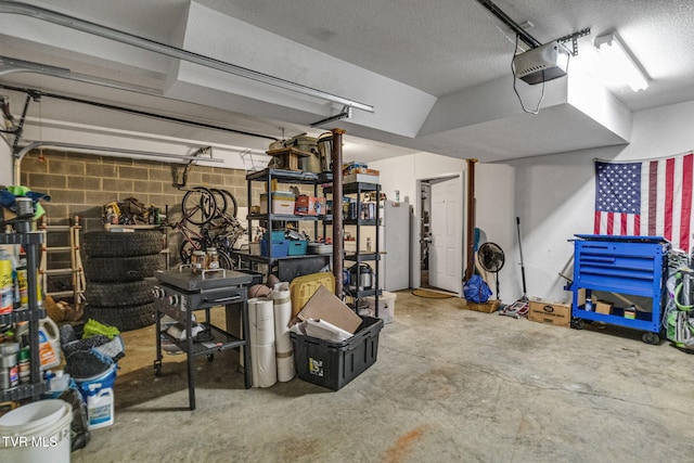 1086 Quaker Run, Telford, TN 37690 - garage with a garage door opener, refrigerator, and concrete block wall