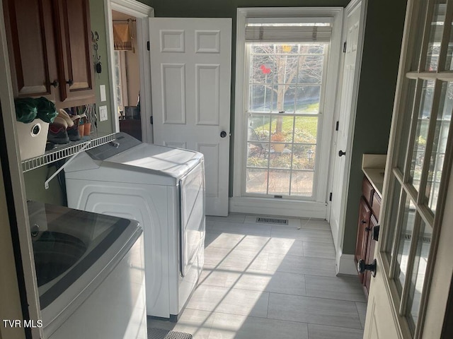 105 Ridgetop Dr, Johnson City, TN 37615 - laundry room featuring cabinet space, separate washer and dryer, and light tile patterned flooring