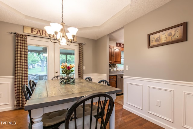 3493 Weaver Pike, Bristol, TN 37620 - dining room with a wainscoted wall, a decorative wall, a chandelier, healthy amount of natural light, and wood finished floors
