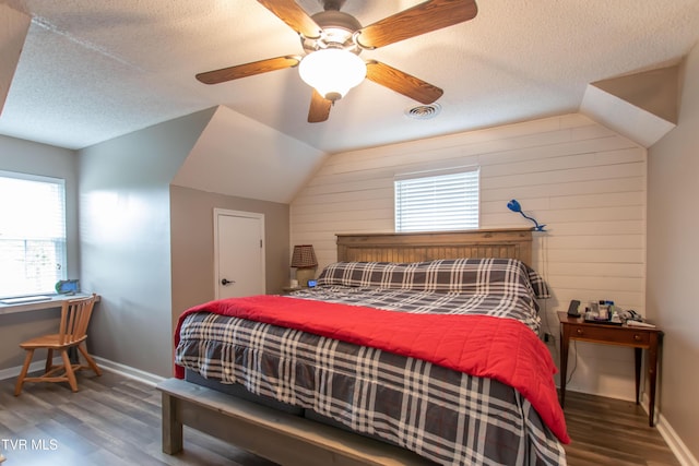 3493 Weaver Pike, Bristol, TN 37620 - bedroom with wood finished floors, multiple windows, lofted ceiling, a textured ceiling, and baseboards