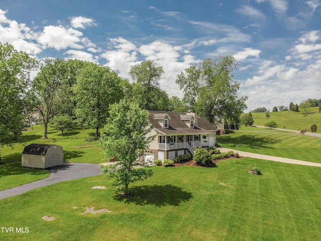 3493 Weaver Pike, Bristol, TN 37620 - cape cod home with an attached garage, a storage unit, asphalt driveway, a porch, and a front yard