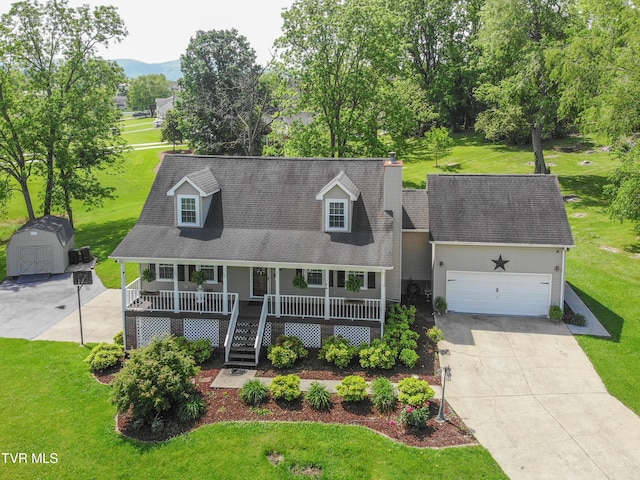 3493 Weaver Pike, Bristol, TN 37620 - cape cod-style house featuring a porch, a storage shed, an attached garage, and a front lawn