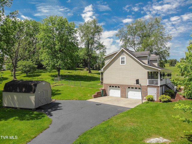 3493 Weaver Pike, Bristol, TN 37620 - view of side of home featuring a storage shed, an attached garage, asphalt driveway, brick siding, and stairs