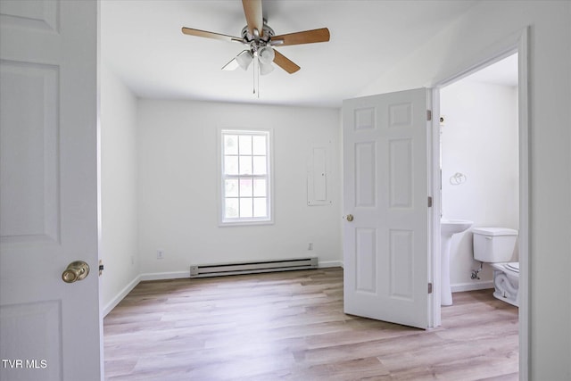 454 Cedar St, Bluff City, TN 37618 - unfurnished bedroom featuring baseboard heating, light wood finished floors, and connected bathroom