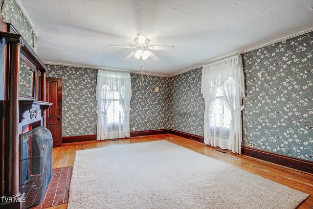 454 Cedar St, Bluff City, TN 37618 - unfurnished living room featuring hardwood / wood-style flooring, plenty of natural light, a ceiling fan, crown molding, and wallpapered walls