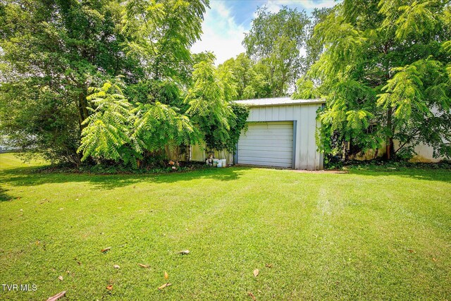 454 Cedar St, Bluff City, TN 37618 - view of green lawn with an outbuilding, a garage, and driveway
