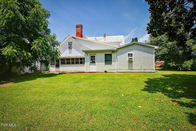 454 Cedar St, Bluff City, TN 37618 - back of house featuring a chimney, a yard, and a sunroom