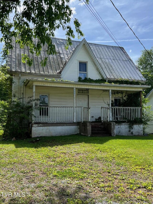 454 Cedar St, Bluff City, TN 37618 - view of front facade with a porch, a standing seam roof, a metal roof, and a front lawn