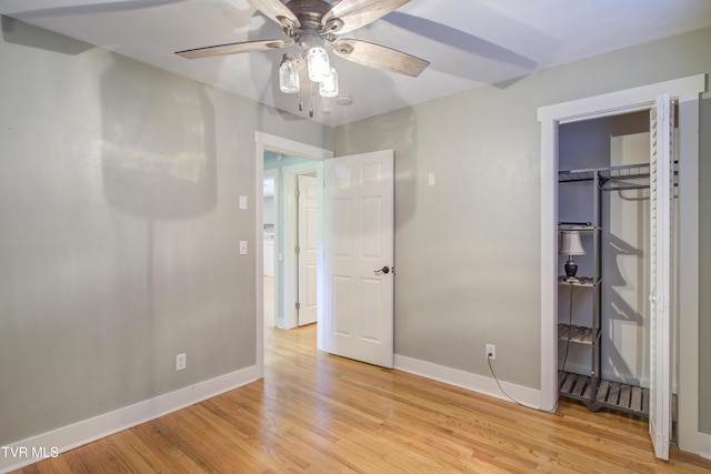 unfurnished bedroom featuring baseboards, light wood-type flooring, ceiling fan, and a closet