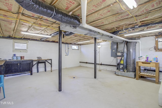 below grade area featuring heating unit and electric panel