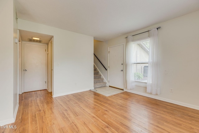 515 Pilgrim Ct Unit B, Johnson City, TN 37601 - empty room with light wood-style floors, stairway, and baseboards